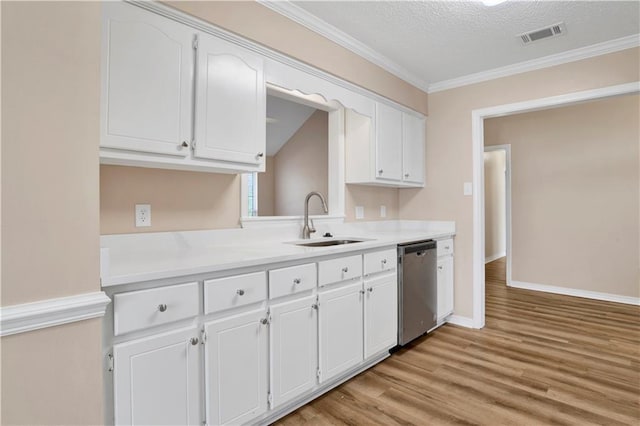 kitchen featuring a sink, white cabinetry, light wood-style floors, ornamental molding, and dishwasher