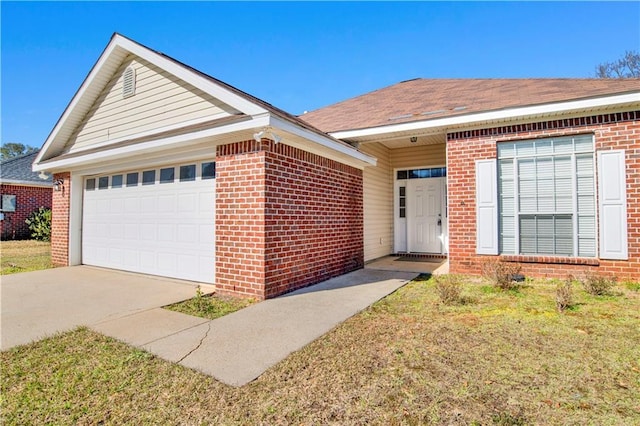 single story home featuring an attached garage, a front lawn, concrete driveway, and brick siding