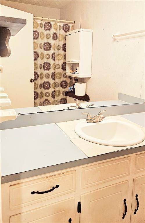 bathroom with water heater and oversized vanity