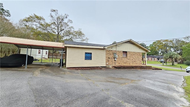 view of front of property featuring a carport