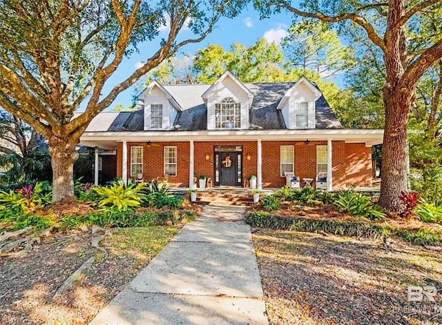 new england style home featuring covered porch