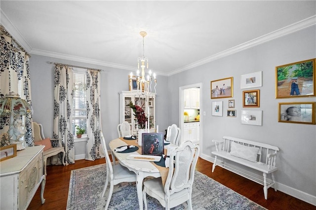 dining area with dark wood-type flooring, crown molding, and an inviting chandelier