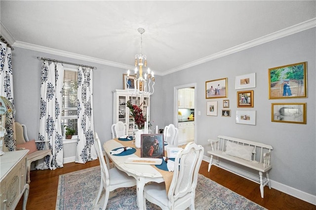 dining room with an inviting chandelier, crown molding, and dark hardwood / wood-style floors