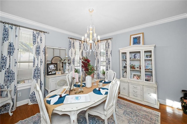 dining space with a healthy amount of sunlight, dark hardwood / wood-style flooring, an inviting chandelier, and ornamental molding