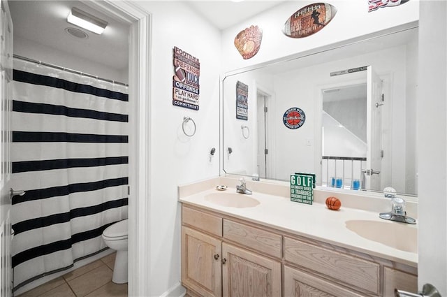 bathroom featuring toilet, tile patterned floors, and vanity