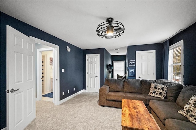 living room with ceiling fan and carpet flooring