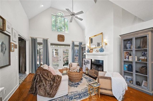 living room featuring high vaulted ceiling, ceiling fan, wood-type flooring, and french doors