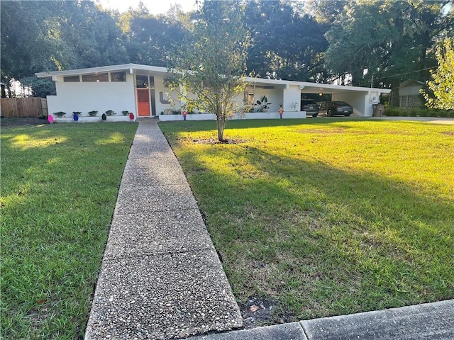 single story home with a front yard and a carport