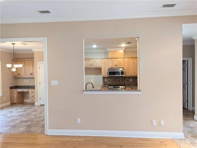 kitchen featuring crown molding, stainless steel appliances, visible vents, backsplash, and light brown cabinets