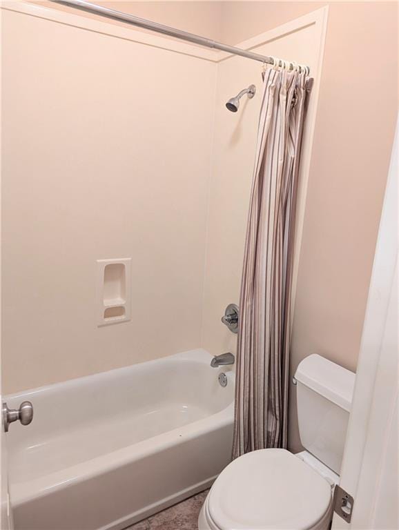 bathroom featuring toilet and shower / bathtub combination with curtain