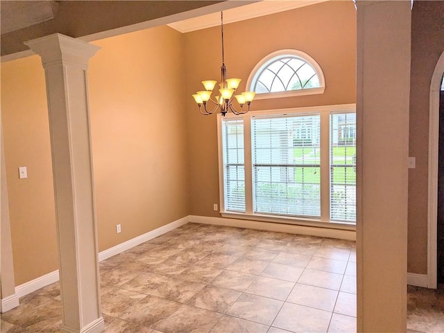 empty room with decorative columns, a chandelier, and baseboards