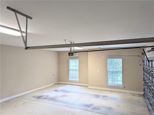 garage with a garage door opener and baseboards