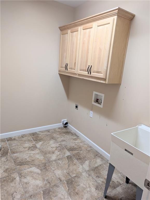 clothes washing area featuring cabinet space, baseboards, electric dryer hookup, washer hookup, and a sink