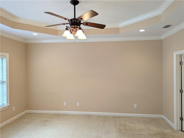 empty room featuring crown molding, baseboards, visible vents, and light colored carpet