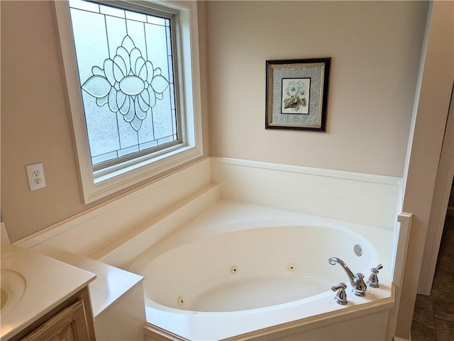 bathroom featuring a whirlpool tub and vanity