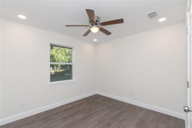 spare room featuring ceiling fan and dark hardwood / wood-style flooring