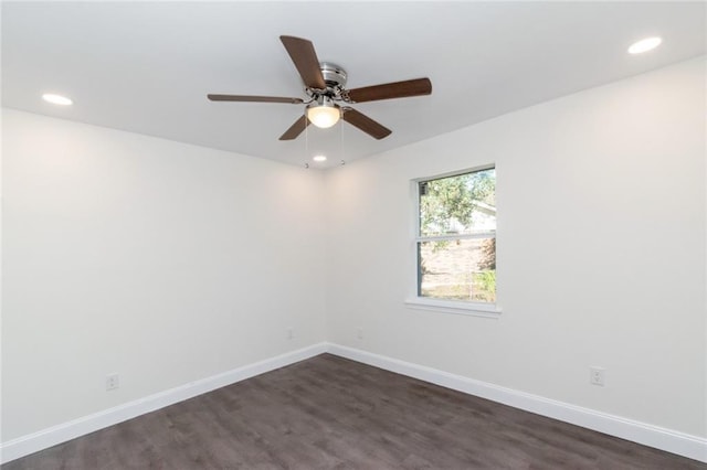 spare room with ceiling fan and dark hardwood / wood-style flooring