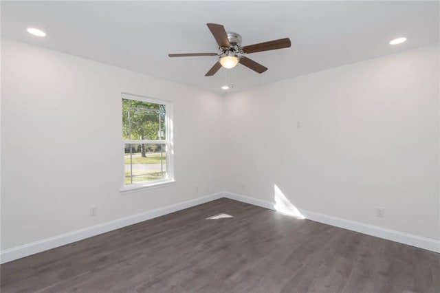 empty room featuring dark wood-type flooring and ceiling fan