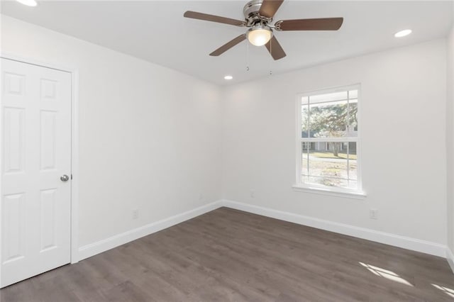 unfurnished room with dark hardwood / wood-style flooring and ceiling fan