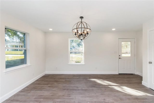 interior space featuring hardwood / wood-style floors and a chandelier