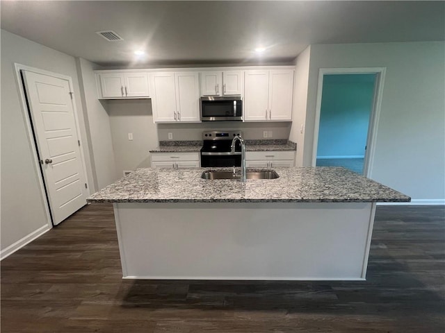 kitchen featuring a center island with sink, appliances with stainless steel finishes, dark hardwood / wood-style flooring, white cabinets, and sink