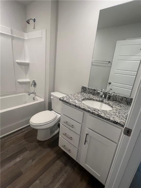 full bathroom with toilet, vanity, shower / tub combination, and hardwood / wood-style floors