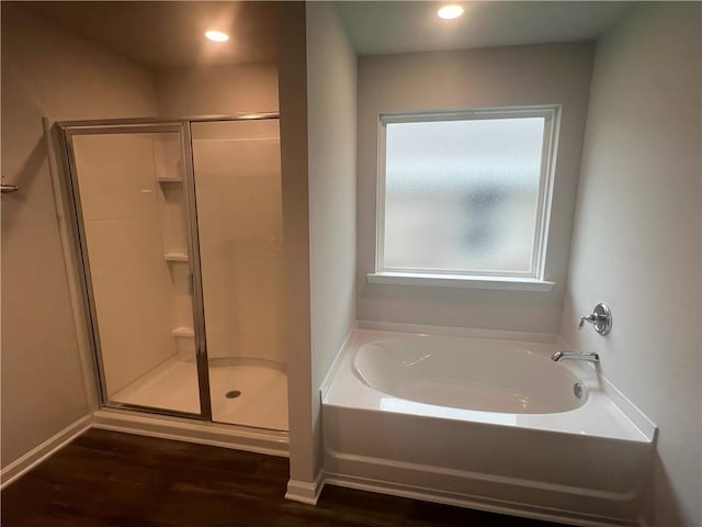 bathroom featuring hardwood / wood-style floors and shower with separate bathtub