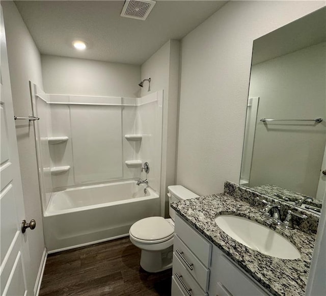 full bathroom with toilet, wood-type flooring, vanity, and shower / bathtub combination