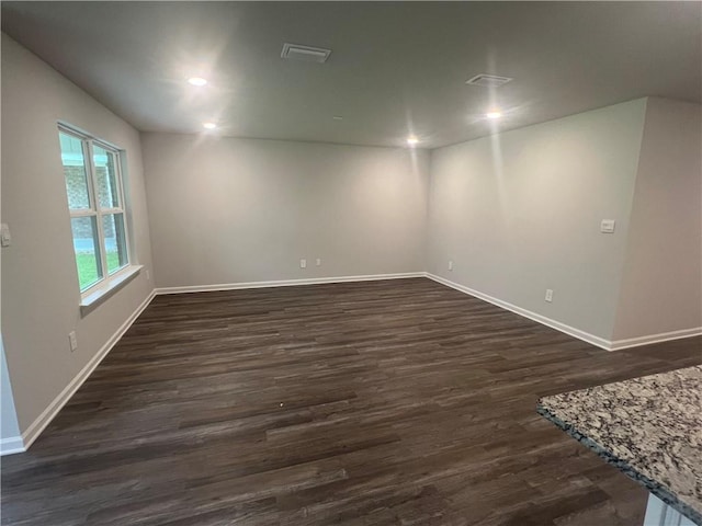 spare room with dark wood-type flooring