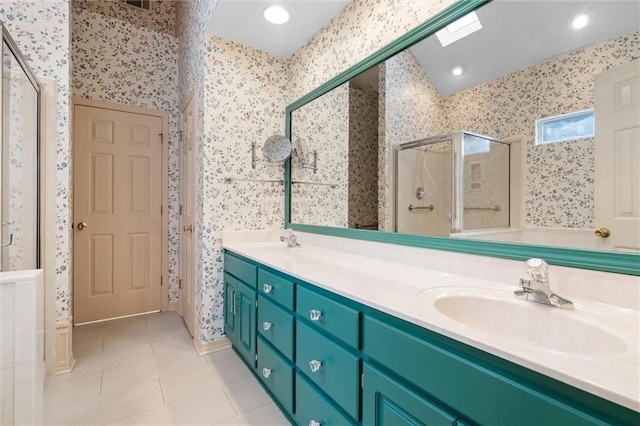 bathroom featuring a shower with door, vanity, and tile patterned floors