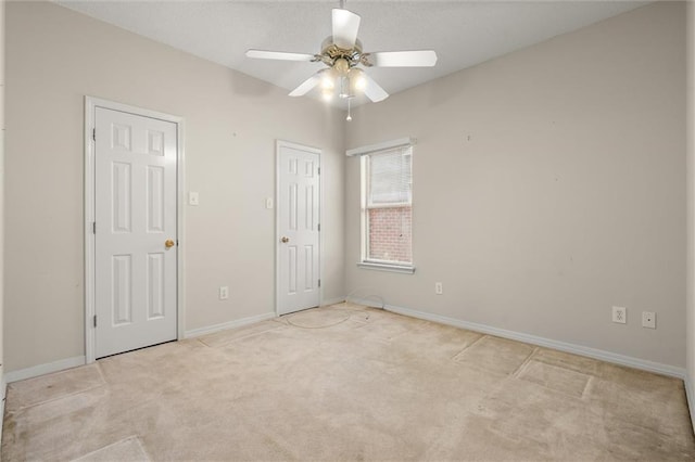 unfurnished bedroom with ceiling fan and light carpet