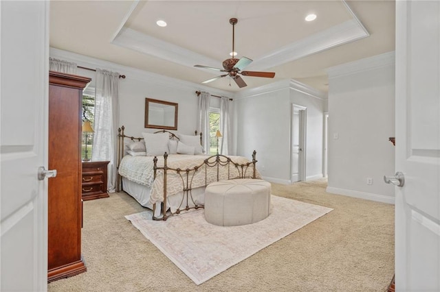 bedroom featuring ornamental molding, light colored carpet, recessed lighting, and a raised ceiling