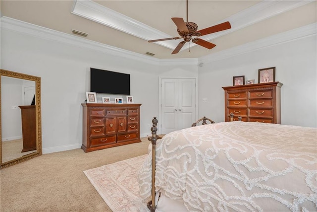 carpeted bedroom featuring a raised ceiling, a closet, crown molding, and visible vents