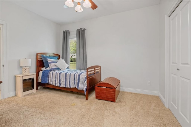 carpeted bedroom featuring a ceiling fan and baseboards