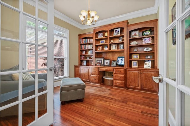 office area featuring a chandelier, light wood-style flooring, and crown molding