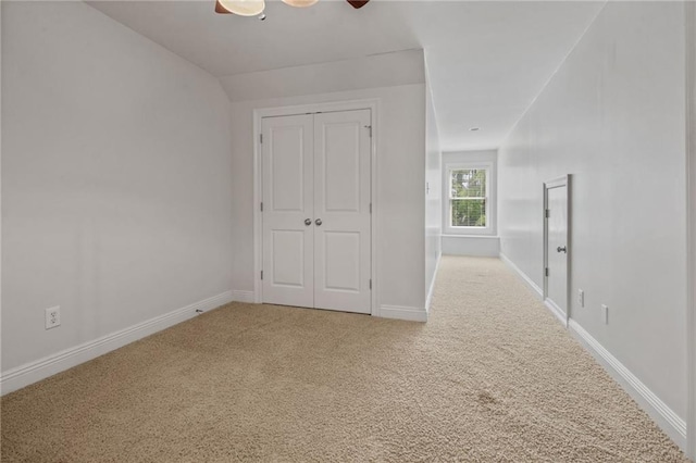 unfurnished bedroom with ceiling fan, baseboards, a closet, and carpet