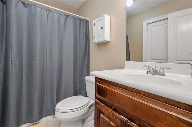 bathroom featuring vanity, tile patterned flooring, and toilet