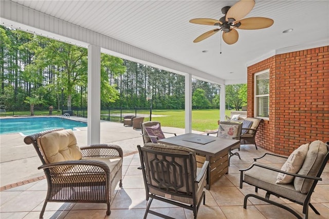 view of patio with outdoor lounge area, a fenced in pool, ceiling fan, and fence