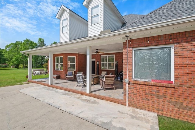 back of property featuring brick siding, an outdoor hangout area, a patio, and ceiling fan