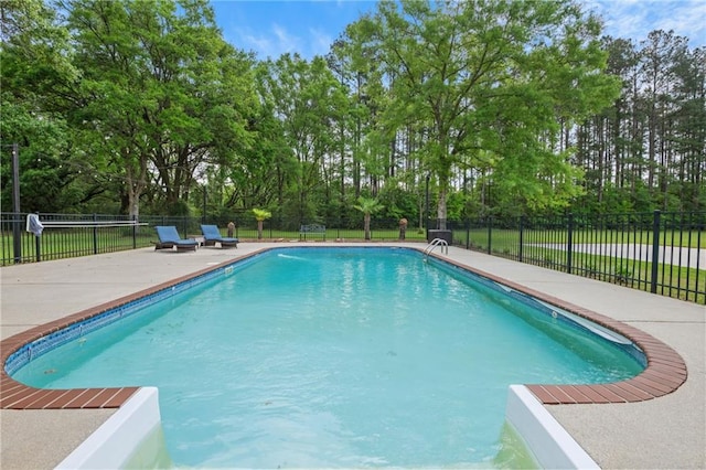 view of swimming pool with fence, a patio area, and a fenced in pool