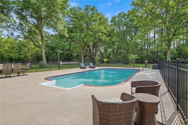 pool featuring fence and a patio area