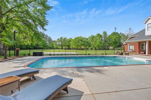 view of swimming pool featuring fence, a patio area, and a fenced in pool
