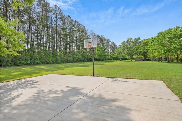 view of basketball court featuring a yard and basketball court