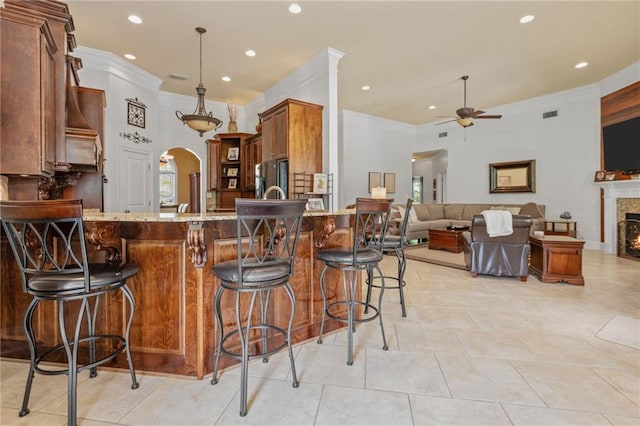 kitchen featuring a ceiling fan, arched walkways, recessed lighting, and crown molding