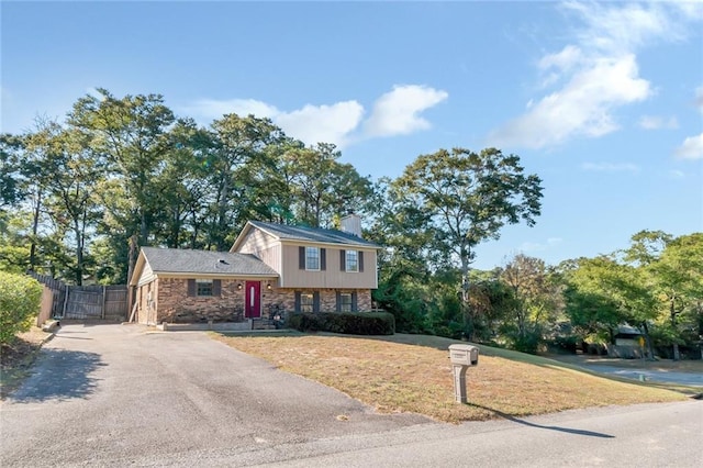 1000 Choctaw Bluff Rd, Mobile, AL 36695 - tri-level home with asphalt driveway, a chimney, and stone siding