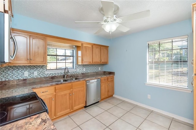 kitchen with sink, light tile patterned flooring, ceiling fan, stainless steel appliances, and decorative backsplash