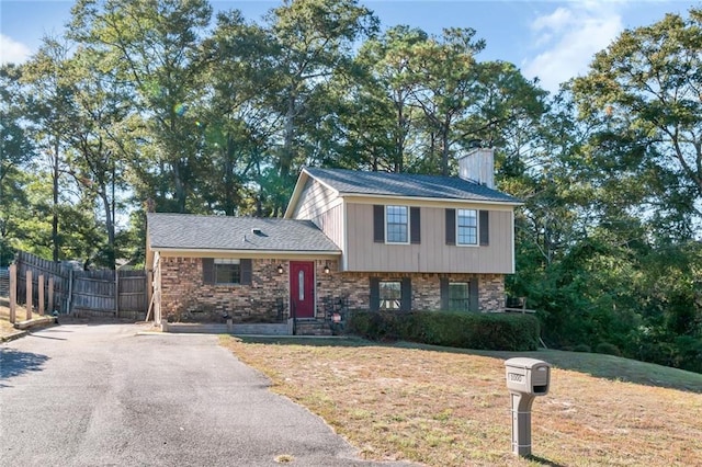 1000 Choctaw Bluff Rd, Mobile, AL 36695 - split level home with asphalt driveway and a chimney