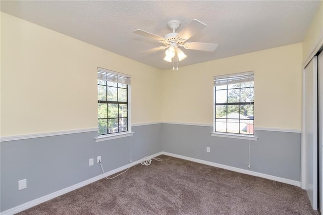 unfurnished room with ceiling fan and carpet floors