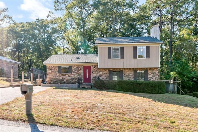 1000 Choctaw Bluff Rd, Mobile, AL 36695 - tri-level home featuring a chimney and brick siding