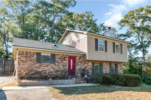 1000 Choctaw Bluff Rd, Mobile, AL 36695 - tri-level home featuring brick siding, fence, and a chimney